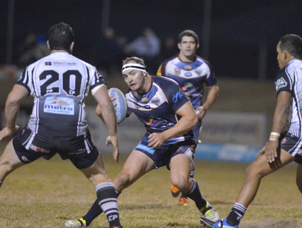 Capras’ Gavin Hiscot goes up against the Souths-Logans’ defence at Marley Brown Oval. Capras’ Gavin Hiscot goes up against the Souths-Logans’ defence at Marley Brown Oval.